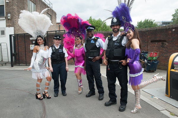 2017 Waterloo Carnival with dancers from London School of Samba and local police posing together