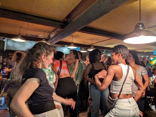 Group of people dancing to Samba music on Theatreship, Canary Wharf