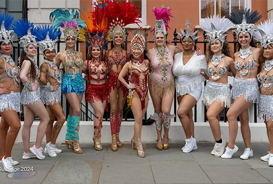 Samber dancers in white and red costumes posing at the 40th Anniversary of London School of Samba in the heart of Covent Garden - Copyright Brian Guttridge