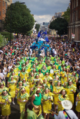 Carnival 2016- Bateria marching toward the camera, the photo is able so the crowd can be seen either side - Copyright Tristan Daws