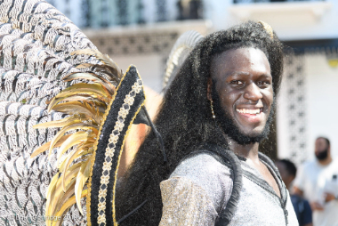 Carnival 2019 - Man in feathers smiling at camera - Copyright Brian Guttridge