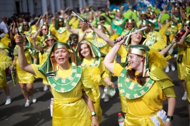 LSS Notting Hill Carnival 2016 - Bateria in yellow holding battons with their arms in the air - Copyright Tristan Daws