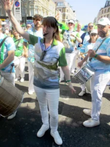 Stacey leading the bateria at carnival - group of drummers following the director