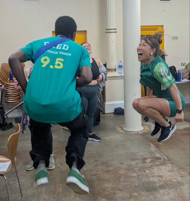 Two people, happily jumping in the air.