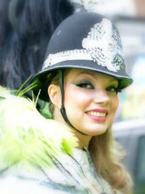 Carnival 2014 - Samba girl in police hat simling at camera - Copyright Mo Elnadi