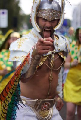 Carnival 2016 -Man with tongue out and wearing white military shoulder armoury - Copyright Tristan Daws