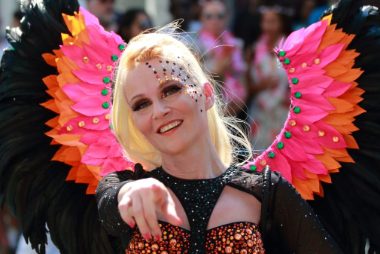 Carnival 2019 -Samba girl pointing, wears black and pink feathers - Copyright Brian Guttridge