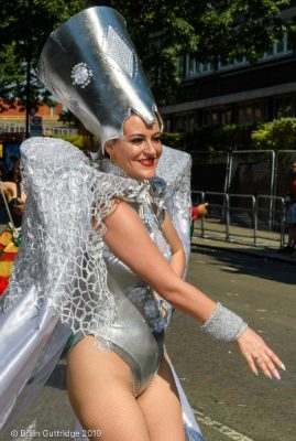 Carnival 2019 -Girl in silver with a large silver hat parading down the street dancing - Copyright Brian Guttridge