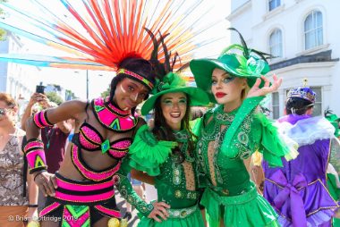 Carnival 2019 -Three dancers, two wearing bright green and the other in pink - Copyright Brian Guttridge