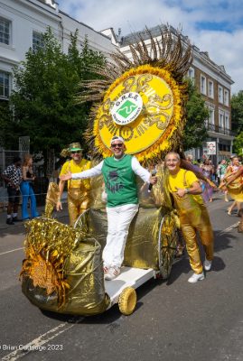 Carnival 2023 - Gold chariot with one man on, being pushed by two in gold outfits