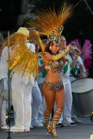 London School of Samba Dancer with band on stage in gold samba dance costume at Panorama 2021