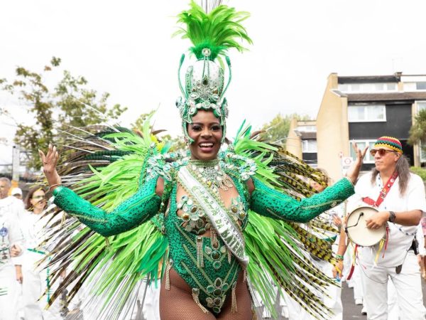 Notting Hill Carnival 2023 - Queen Keon - woman in green feathered samba costume - Copyright Dexter Lewis